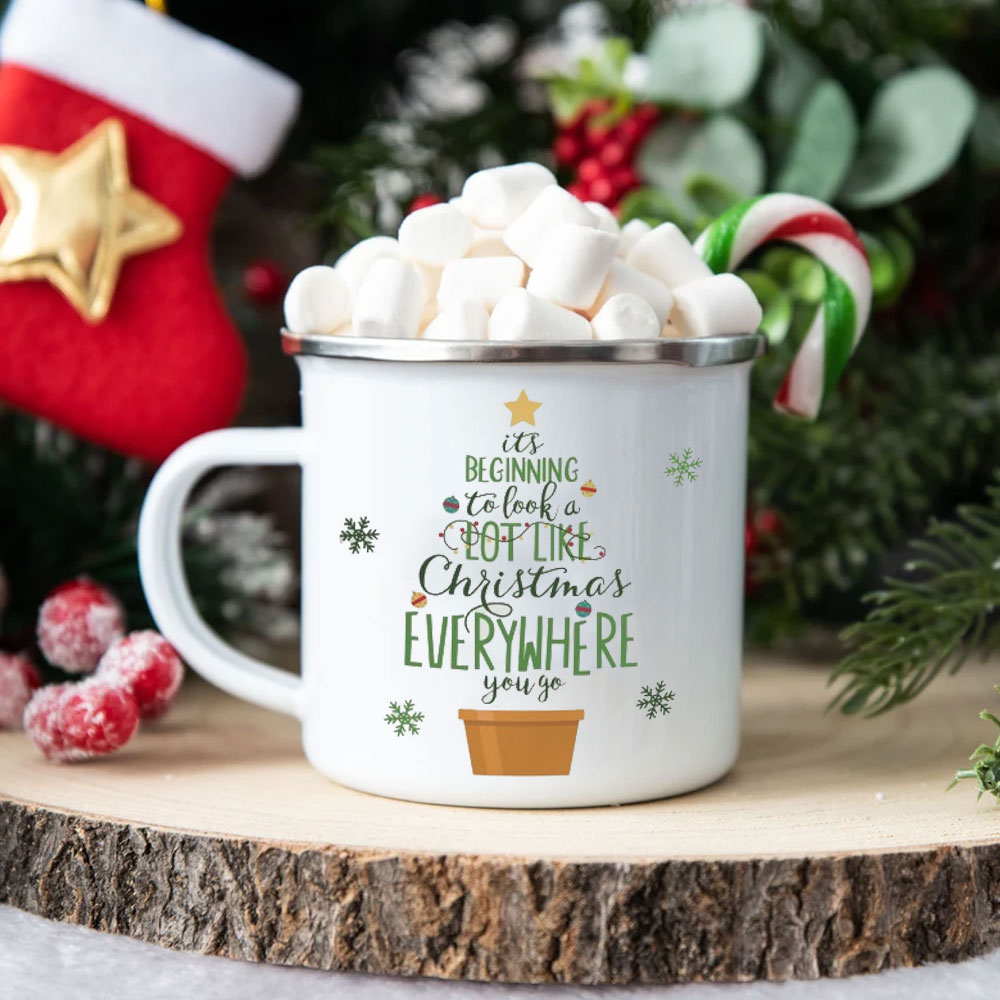 Personalised sublimation camping mug filled with marshmallows and a candy cane, showcasing cosy Christmas sublimation ideas for unique seasonal gifts.